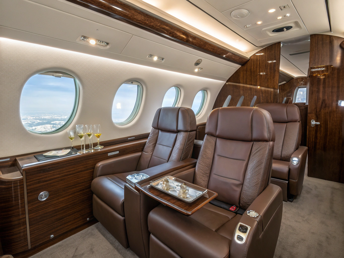 Luxury private jet cabin interior with hand-stitched leather seating and champagne service